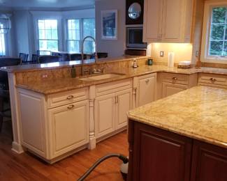 Base cabinets include a trash corral and a dishwasher