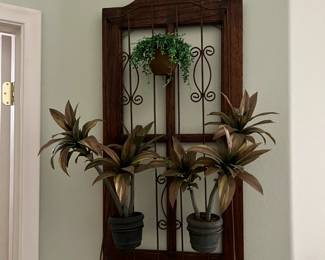 iron and wooden wall decor with faux plants