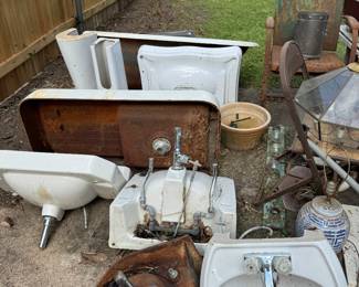 Lots of vintage plumbing fixtures, pedestal sinks, cast iron tub