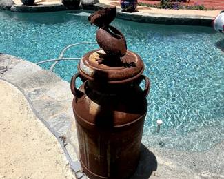Antique milk jug and metal pelican.