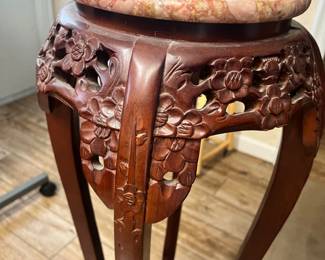 Carved wooden base with a marble top