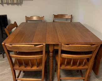 This is sooooo nice! Willett cherry dining set. Four side chairs - two arm chairs…large drop leaves…love it! Picture only shows one leaf up.
