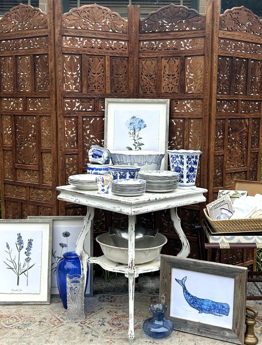 Beautiful Indian screen, lots of blue - art, vases, plates, and more, shabby chic table, woven trays, framed botanicals, rug runner with muted colors. 