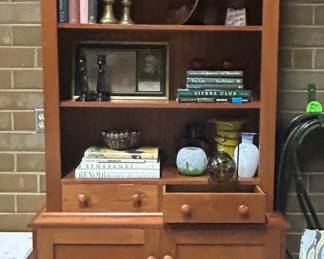 Handsome tall cherry piece with vintage iron weights, lovely books, decorative glass vases, and black candlesticks.  