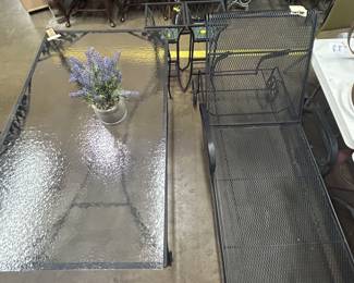 Woodard patio furniture (black) - lounge chair and a 6-seat glass table top with wrought iron frame and base (no chairs).