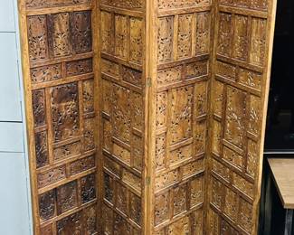 A classic four-panel folding (reversible) screen, hand-carved from (possibly) mango wood, likely from the Rajasthan region in India, possibly early-to-mid 20th c.  Measures 72" H by 19.5" W per panel.  
