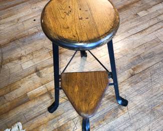 Industrial stool with collapsible foot rest