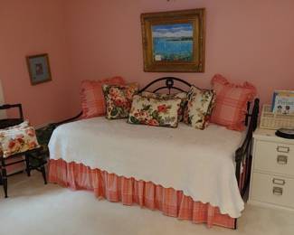 wrought iron day bed, wooden file cabinet, painting