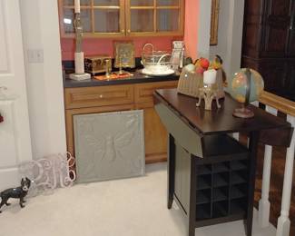 drop leaf table with wine rack, cast iron dog, globe, fishing basket, glass fruit