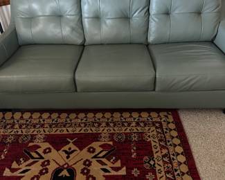 Leather couch with bed inside
