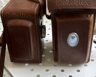 Two vintage Rolleiflex cameras with cases