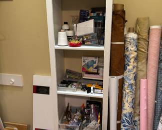 Lots of paint brushes and craft supplies, tablecloth and fabric
