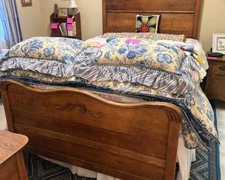 Antique oak full-size bed adjusted to queen size mattress