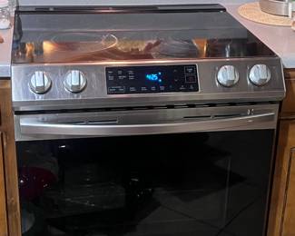 Kitchen. This stove is a flat-top Samsung. Although mother did a lot of cooking, a lot, this stove was purchased only 2 years ago after mother had stopped cooking. It has been used very little.