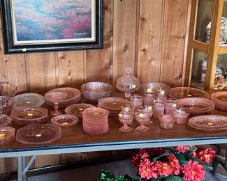This table is located on the left side of the living room. Mother and Daddy both enjoyed collecting the Pink Miss America Depression glassware. There is at least one more type of pink depression glass to the left of the Miss America. The large framed picture hanging on the wall for sale along with the silk flower located under the table.
