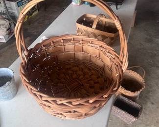 Located in garage. There are several woven baskets that are different shapes and sizes.