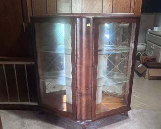 This curved front curio is located in the hallway off the living room. It housed many of mother's angel figurines for several years.