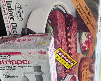 Located in the garage. Indoor grill and a an automatic peeler. There is also a George Foreman grill on this table.