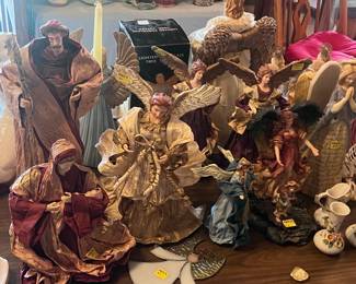 This table in located in the center portion of the living room towards the dining area. There are paper mache with porcelain heads angels and a Mary & Joseph.