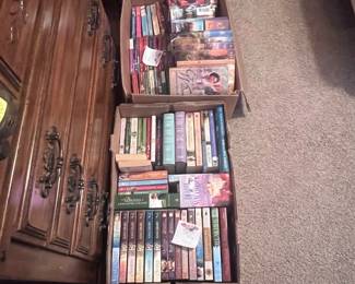 Mother was an avid reader. These boxes of books are located in the red bedroom. There are many other books similar to these throughout the house and garage.