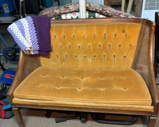 Antique caned and upholstered love seat