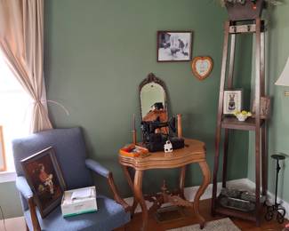 Ornate Side Table, Vintage Sewing Machine and Antique Mirror! Unique Coat Rack and Shelf in the Corner and Comfy Blue Chair on Casters!