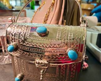 Dramatic metal special occassion baag with faux turquoise accents.