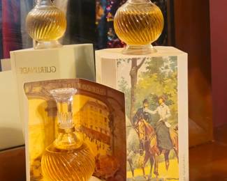 "Guerlinade" by Guerlain. Two bottles with box. One has the scroll and is priced slightly higher. (The reflection makes it appear to be three bottles.)