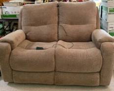 Love seat and matching couch (not shown). Has electric foot rests.