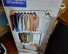 Clothing Rack in box Black with 3 gray drawers and on casters.