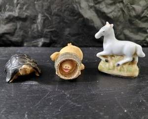 Decorative pig with head stuck in a bucket and a small horse, and a turtle, very cute.