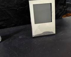 Silver picture frame has some dings, but glass and backing are good, 4x5.