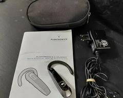Plantrontics 300 Series Bluetooth Earbud, with container, charger, and manual.