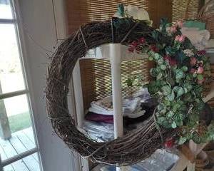Grapevine Wreath with flowers and greenery attached.