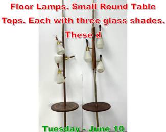 Lot 718 2pc Tension Rod Modernist Floor Lamps. Small Round Table Tops. Each with three glass shades. These d