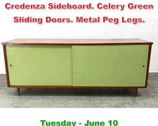 Lot 612 Paul McCobb style Walnut Credenza Sideboard. Celery Green Sliding Doors. Metal Peg Legs.