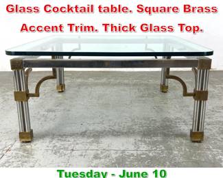 Lot 817 Regency style Chrome Glass Cocktail table. Square Brass Accent Trim. Thick Glass Top.