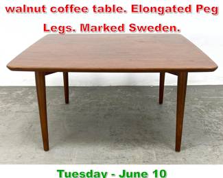 Lot 896 Dux Swedish Modern walnut coffee table. Elongated Peg Legs. Marked Sweden.
