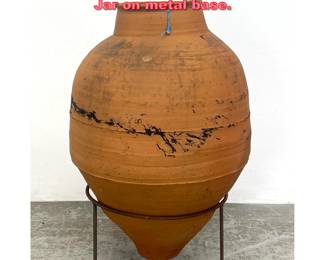 Lot 1488 Large Terra Cotta planter Olive Jar on metal base.