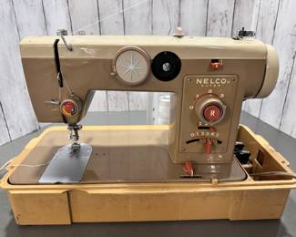 Vintage Nelco Sewing Machine w/sewing notions and lots of upholstery fabrics on rolls