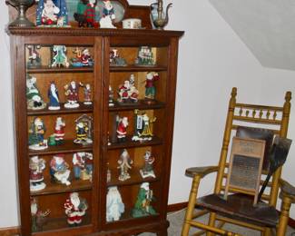 Antique Oak carved bookcase full of a Collection of Santa's