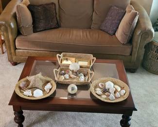 Ethan Allen sofa (leather, suede, nailhead trim), Ethan Allen coffee table (wood, glass, rattan), shells.