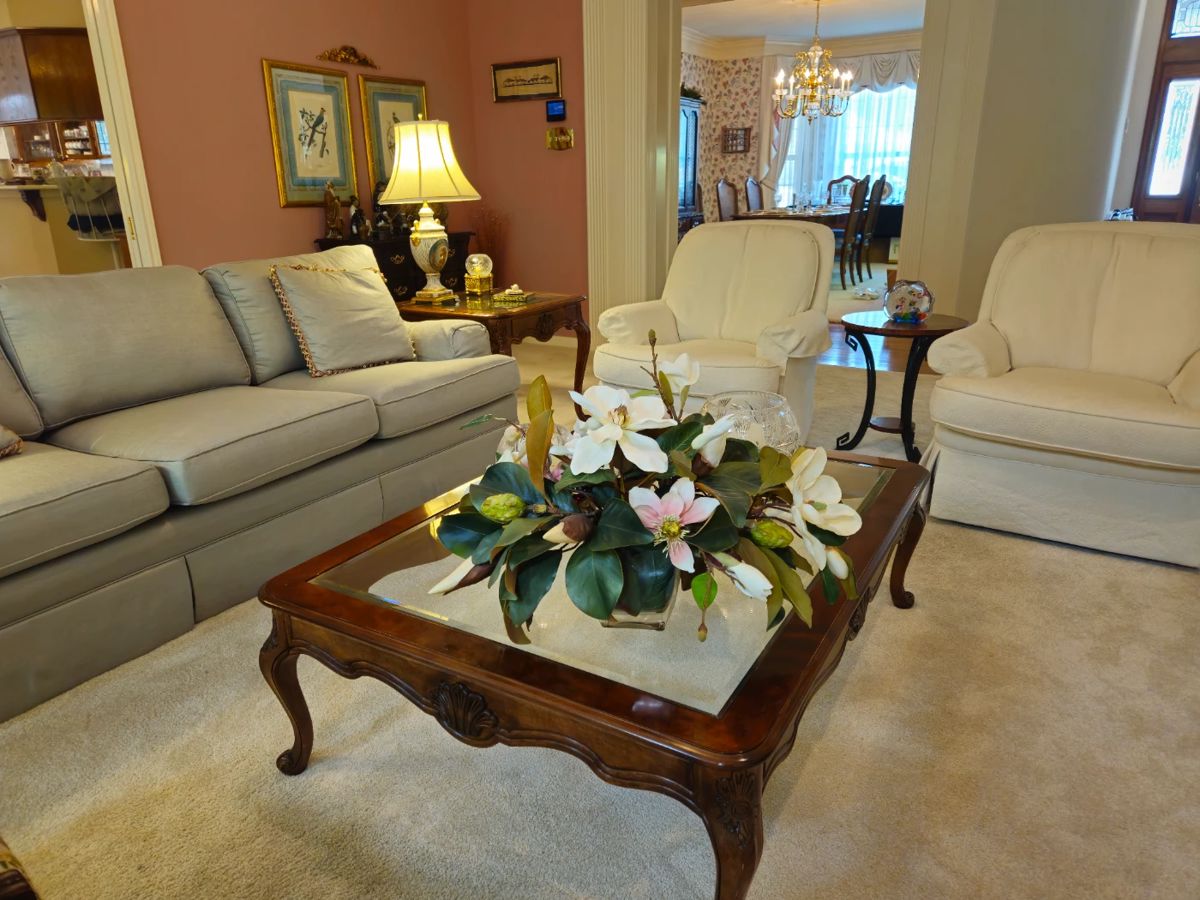 Blue silk sofa, rectangular coffee table and pair of His and Hers swivel rockers.