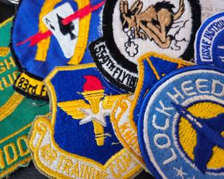 A few of the dozens of uniform badges. Most are in worn condition.