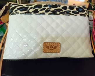 Consuela clutch in white quilted design with leopard trim. Leather fringe type trim on each end, with colorful strap. New.