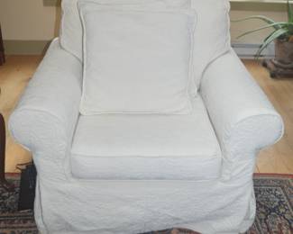 Comfy oversized chair with throw pillow and tailored slipcovers