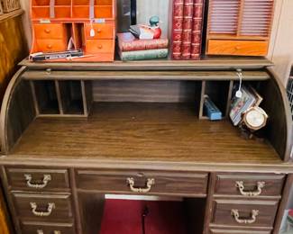 We have two vintage rolled-top desks.