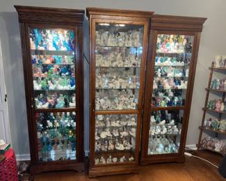 Curio cabinets filled with Fenton and Lenox cats. Cabinets will be for sale but HAVE TO BE PICKED UP AFTER THE SALE.