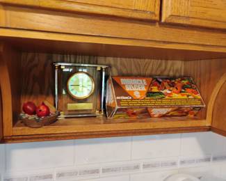 CLOCK AND OTHER ITEMS ON KITCHEN SHELF