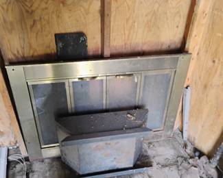 OLD FIREPLACE INSERT AND COVER IN BACK SHED.